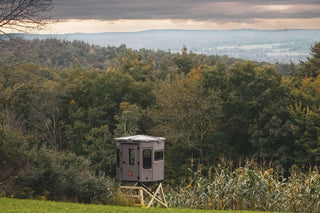 Halloween deer hunting grizzly elevated hunting blind overlooking a valley of trees with fall colors